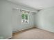 Cozy bedroom featuring a window with a view and neutral paint color, offering a simple aesthetic at 3975 Offshore Dr, Columbus, IN 47203