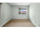 Small bedroom with neutral carpet, a window with neighborhood view, and light walls at 3975 Offshore Dr, Columbus, IN 47203