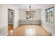 Bright dining room with hardwood floors, modern lighting fixture, and large windows at 3975 Offshore Dr, Columbus, IN 47203