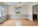 Bright dining room with hardwood floors, modern lighting fixture, and a scenic window view at 3975 Offshore Dr, Columbus, IN 47203