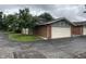 View of the attached garage featuring a brick exterior and well-maintained surroundings at 3975 Offshore Dr, Columbus, IN 47203