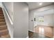 Hallway with a staircase leading to an open living area filled with natural light at 3975 Offshore Dr, Columbus, IN 47203
