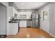 Well-lit kitchen with stainless steel appliances, white cabinets, and hardwood flooring at 3975 Offshore Dr, Columbus, IN 47203