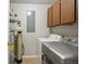 Functional laundry room with washer, dryer, storage cabinets, and utility connections at 3975 Offshore Dr, Columbus, IN 47203