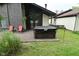 Backyard deck with a covered hot tub, greenery, and an inviting outdoor space at 4029 Gamay Ln, Indianapolis, IN 46254