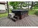 Deck with a hot tub and wooden bench, perfect for relaxation in a private setting at 4029 Gamay Ln, Indianapolis, IN 46254