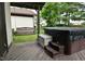 Cozy covered deck with a swing, hot tub, and a tranquil outdoor setting at 4029 Gamay Ln, Indianapolis, IN 46254