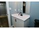 Bathroom with a white vanity, black faucet, and blue walls at 4029 Gamay Ln, Indianapolis, IN 46254