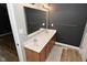 Bathroom with a double sink vanity, large mirror, and gray walls at 4029 Gamay Ln, Indianapolis, IN 46254