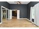 Spacious bedroom with wood floors, a ceiling fan, and an open doorway at 4029 Gamay Ln, Indianapolis, IN 46254