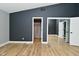 Bedroom with dark walls, wood floors, and mirrored closet doors at 4029 Gamay Ln, Indianapolis, IN 46254