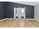 Bedroom features wood floors, a large window, and dark accent wall at 4029 Gamay Ln, Indianapolis, IN 46254