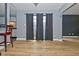 Dining room features light wood floors and view of the kitchen and curtains covering an exterior door at 4029 Gamay Ln, Indianapolis, IN 46254