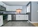 Modern kitchen with stainless steel appliances, gray walls and dark counter tops at 4029 Gamay Ln, Indianapolis, IN 46254