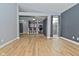 Open living room with vaulted ceilings, light wood floors, and eat-in bar looking into the kitchen at 4029 Gamay Ln, Indianapolis, IN 46254