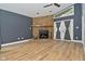 Cozy living room with stone fireplace, high ceilings, and hardwood floors and door to the exterior at 4029 Gamay Ln, Indianapolis, IN 46254