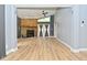 Open living room with stone fireplace, high ceilings, hardwood floors, and door to the exterior at 4029 Gamay Ln, Indianapolis, IN 46254