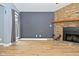 Living room with stone fireplace, hardwood floors, and view of the exterior through the window at 4029 Gamay Ln, Indianapolis, IN 46254