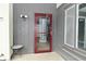 Outdoor patio area, screened door, wood siding, and an exterior light fixture at 4029 Gamay Ln, Indianapolis, IN 46254