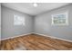 This bedroom is equipped with newer flooring, neutral paint, two large windows and lots of light at 420 Vista Dr, Carmel, IN 46280
