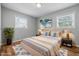 Bright bedroom with decorative pillows and blankets, wood floors, and lots of natural light at 420 Vista Dr, Carmel, IN 46280