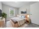 Stylishly staged bedroom with light wood bed frame, soft rug, and ample natural light from the window at 420 Vista Dr, Carmel, IN 46280