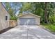 Detached one car garage with a concrete drive and mature shade trees at 420 Vista Dr, Carmel, IN 46280
