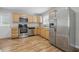 Modern kitchen features stainless steel appliances, light wood cabinets, and hardwood floors at 420 Vista Dr, Carmel, IN 46280