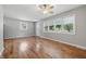 Sunny living room boasts hardwood floors, neutral paint, and large windows, perfect for relaxing or entertaining guests at 420 Vista Dr, Carmel, IN 46280