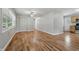 Spacious living room featuring hardwood floors, abundant natural light from large windows, and a ceiling fan for comfort at 420 Vista Dr, Carmel, IN 46280