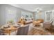 Bright living room featuring hardwood floors, neutral paint, large window, ceiling fan and modern decor at 420 Vista Dr, Carmel, IN 46280