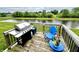 Back deck featuring a grill with a view of the pond at 4209 Switchgrass Way, Indianapolis, IN 46237