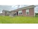 A beautiful brick home with a lovely wooden deck and spacious backyard with lush green grass at 4209 Switchgrass Way, Indianapolis, IN 46237