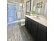 Bathroom with a glass shower and a modern vanity with dark cabinets at 4209 Switchgrass Way, Indianapolis, IN 46237