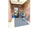 Cozy entryway features a black front door, blue chairs, and patterned rug at 4209 Switchgrass Way, Indianapolis, IN 46237