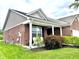 Well-kept red brick home featuring an inviting front porch with chairs at 4209 Switchgrass Way, Indianapolis, IN 46237