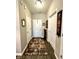 Inviting hallway with neutral walls, wooden floors, and decorative mirrors and artwork at 4209 Switchgrass Way, Indianapolis, IN 46237