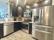 Modern kitchen featuring stainless steel appliances and dark cabinets at 4209 Switchgrass Way, Indianapolis, IN 46237