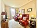 Cozy living room featuring two red leather chairs and natural light at 4209 Switchgrass Way, Indianapolis, IN 46237