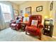Comfortable living room featuring two red leather chairs and natural light at 4209 Switchgrass Way, Indianapolis, IN 46237