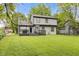 Exterior view of a home with a spacious, green backyard, deck, and grill at 4736 Rocky Knob Ln, Indianapolis, IN 46254