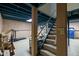 Basement steps with pink wallpapered walls, an unfinished ceiling, and concrete flooring at 4736 Rocky Knob Ln, Indianapolis, IN 46254