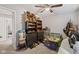 A very cluttered bedroom with carpet flooring and ceiling fan at 4736 Rocky Knob Ln, Indianapolis, IN 46254