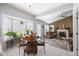 Open-concept living room features a dining area, fireplace, ceiling fan, and an abundance of natural light at 4736 Rocky Knob Ln, Indianapolis, IN 46254