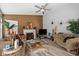 Spacious living room with hardwood floors, a fireplace, ceiling fan, and stylish furniture at 4736 Rocky Knob Ln, Indianapolis, IN 46254