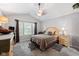 This is a carpeted main bedroom with a ceiling fan and an ensuite bathroom at 4736 Rocky Knob Ln, Indianapolis, IN 46254