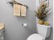 Bathroom corner showcasing a toilet, decorative towels, and wall decor with neutral gray wall color at 4736 Rocky Knob Ln, Indianapolis, IN 46254