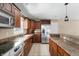 Spacious kitchen with stainless steel appliances and dark wood cabinetry at 4904 N Tillotson Ave, Muncie, IN 47304