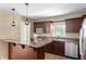 Open concept kitchen with breakfast bar and stainless steel appliances at 4904 N Tillotson Ave, Muncie, IN 47304