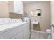 Bright laundry room with modern washer and dryer, cabinet storage, sink, and toilet at 4904 N Tillotson Ave, Muncie, IN 47304